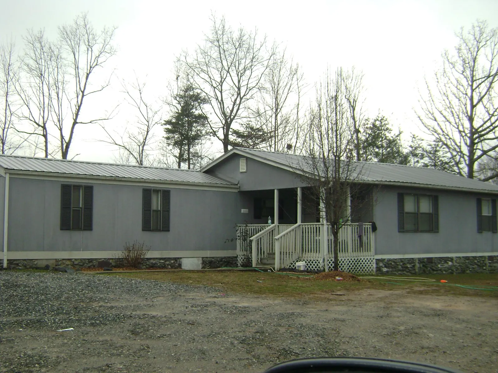Metal roof over a manufactured home with a covered front porch in Millville