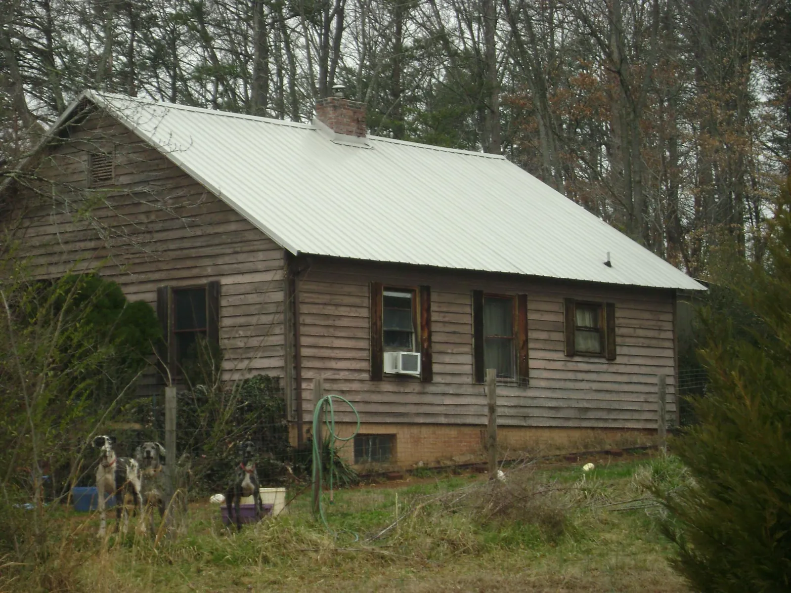 White metal roof on an old wood sided farmhouse, from a Metal Roof Installation job in Millville